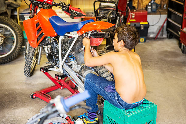 Boy Working on Dirt Bike