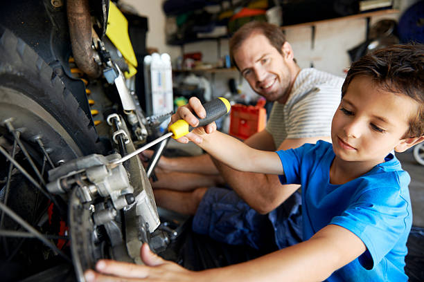 Father and Son Repairing Motorcycle